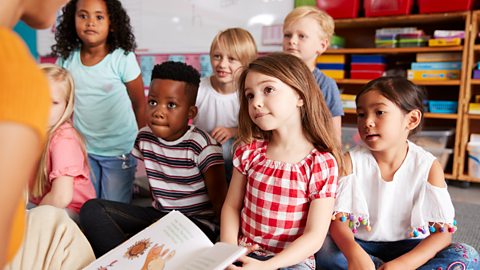 Children listen to a story in class