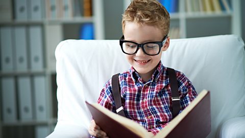 Little boy looking at dictionary