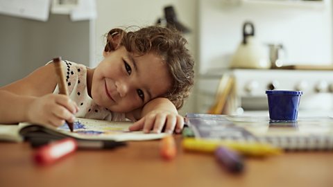 A little girl with a colouring book