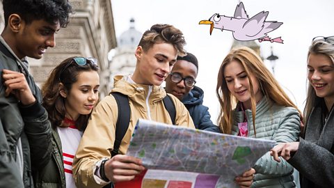 A photo of students looking at a map of London