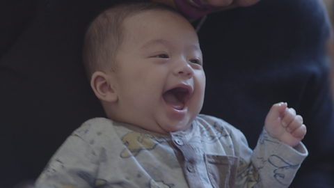 Baby laughing out loud.