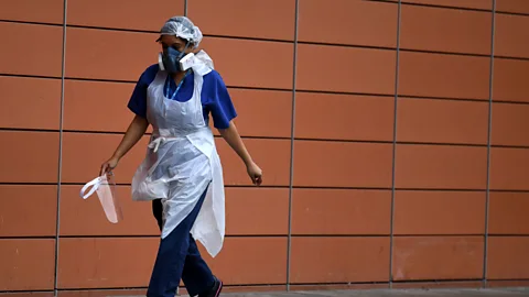 A nurse walks outside The Royal London Hospital on 18 April 2020