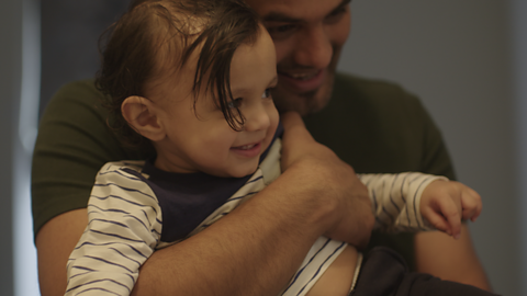 Close up of dad holding toddler.