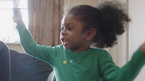 Child holding their arms in the air.