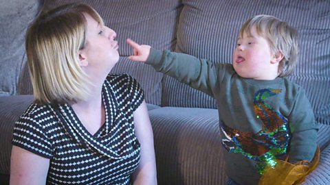 A mum blowing a raspberry for her son.