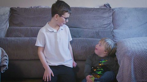 Two brothers blowing raspberries.