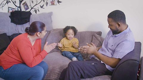 A family singing and clapping.