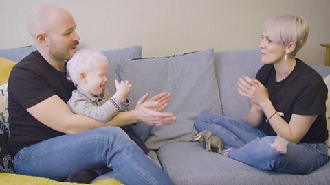 A family singing and clapping.