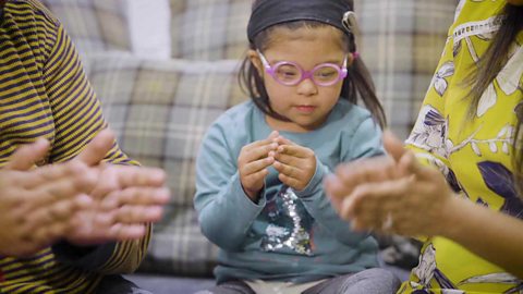 A little girl doing the actions to a rhyme.