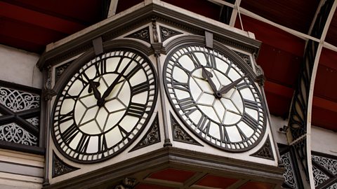 A photograph of an electric station clock.