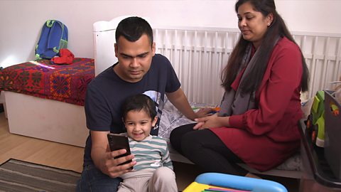 Mum, dad and son talking to phone screen