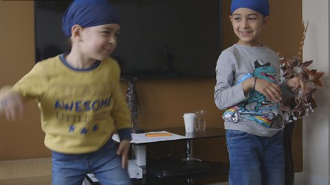 Two children dancing. 