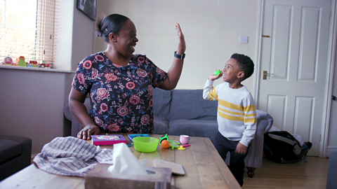 Mum and son high-fiving.