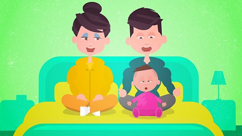 A cartoon showing mum, dad and baby. Baby is sitting up on the bed with them both.