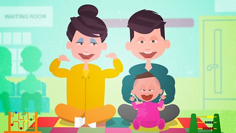 A cartoon showing mum, dad and baby. Baby is sitting with dad in a waiting room.