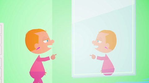 Cartoon baby with a red mark on their face looking in a mirror.