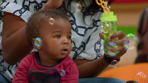 Baby and mum looking at bubbles.