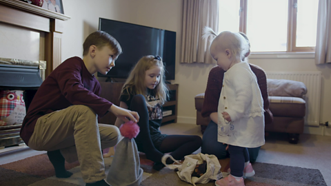 Family sat on floor of lounge.