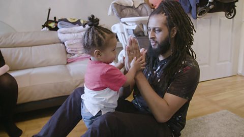 Dad clapping with toddler.