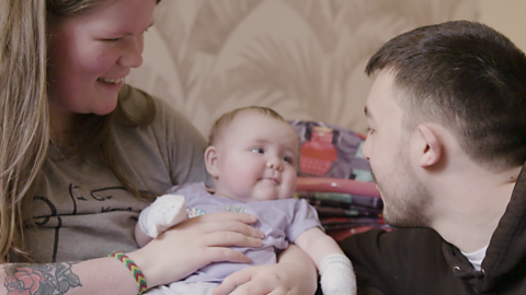 Baby looking at their dad. 