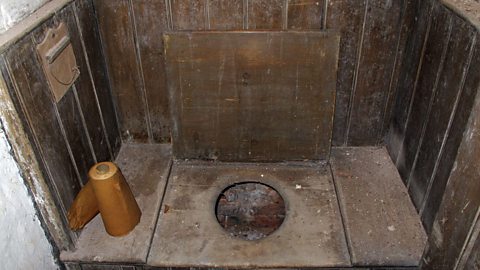 A view of a Victorian privy, an outside toilet with very basic facilities. 