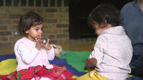 Two little girls at a parent/toddler group.