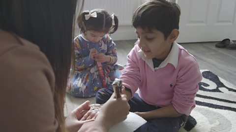 Ashir doing some drawing with her children.