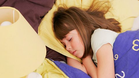 Young girl sleeping in bed