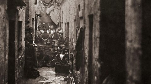 A view of a narrow Glasgow slum.