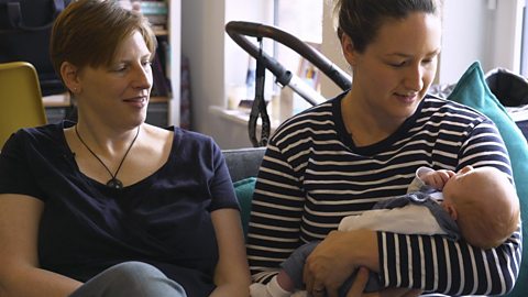 Two mums and their newborn baby.