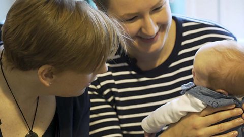 2 mums with their very small baby.