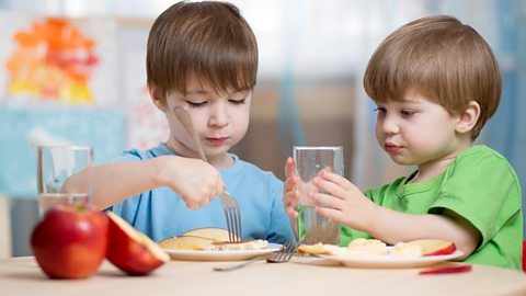 Boys eating healthy food at home