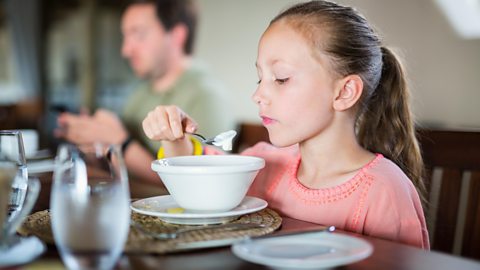 Young girl eating breakfast