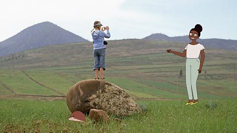 A girl taking a photograph of the surrounding landscape with a camera