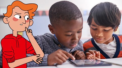 Two boys analysing their findings by looking at photos on a tablet