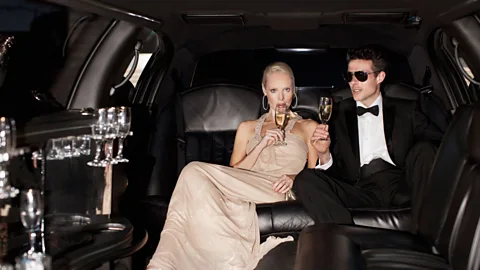 Couple drinking champagne in limo