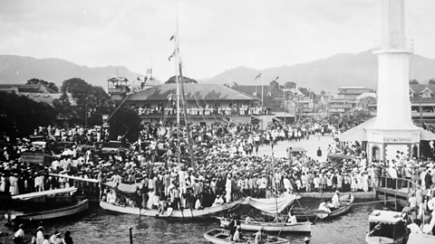 A port in Jamaica filled with ships and the BWIR boarding them. 