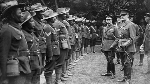 A photograph of king George V with SANLC troops.