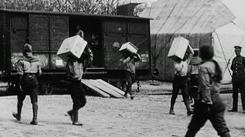 SANLC members carrying crates from cargo trains.