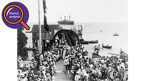 A crowd waiting at a St Vincent port for a ship transporting the BWIR to dock.