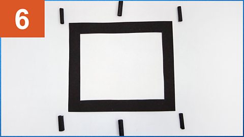 A frame with spacers at each corner and in the middle of the two long sides