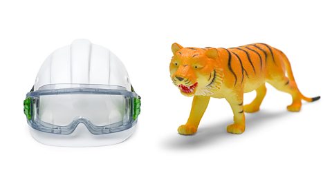 A safety helmet, safety googles and toy tiger, all made from plastic