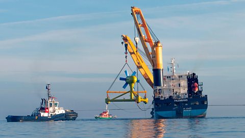 Ships aid in the install of a tidal turbine under water