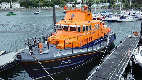 Orange lifeboat waiting in harbour