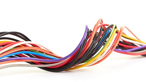 Multicoloured cables twisted together.