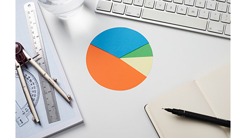 An image of a pie chart with a ruler, protractor and pair of compasses in the background.