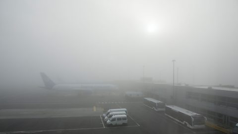 A plane on a runway during very thick fog.