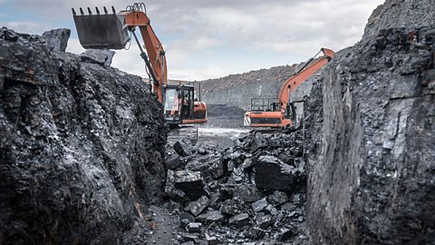 Diggers digging up coal