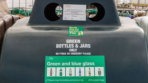 A glass recycling bin