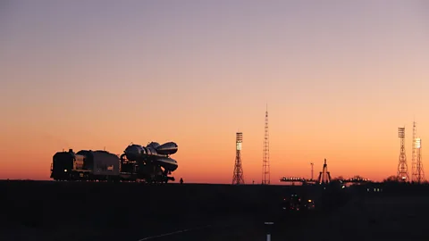Russian spacecraft is pulled by train from hangar to launch pad at Baikonur Cosmodrome